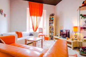 a living room with a couch and a tv at Albergo Villa Gaia in Chianciano Terme