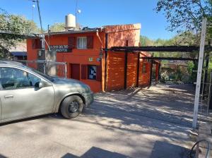 un pequeño coche aparcado frente a un edificio en Cabañas la Casa del Tata, en Potrero de los Funes