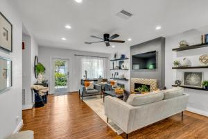 a living room with a couch and a fireplace at Special Pricing, Las Olas Retreat, Heated Pool, Golf and Family-Ready in Fort Lauderdale