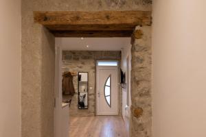 a hallway of a house with a stone wall at 1 Appartement OU Chambres privées en centre ville Choisissez UNE option in Bonneville