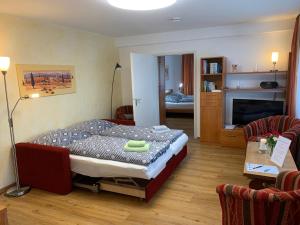 a bedroom with a bed and a living room at Ferienwohnung Heimweg in Feldberg