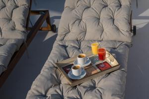 a tray with two cups of coffee on a bed at Acropolis and Odeon Panorama in Athens +30 photos