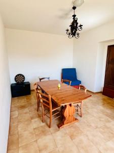 a dining room with a wooden table and chairs at Rifugio Acquaviva in Formia