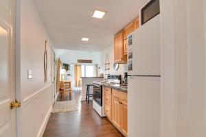 a kitchen with white appliances and wooden cabinets at Lake George Waterfront Cabin with On-Site Marina! in Bolton Landing