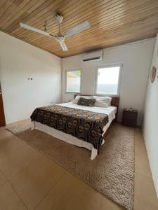 a bedroom with a large bed with a wooden ceiling at Emron Homelodge in Accra