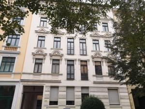 a white building with many windows on the side of it at RR - Spacious Apartments - Central - Parking in Magdeburg