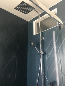a shower with a shower head in a bathroom at Origami • Hippod. Enghien • 30 mn Paris in Eaubonne +28 photos