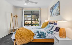 a bedroom with a bed and a window at Deja Blue - 4 La Ronde in Carrickalinga