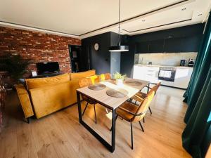 a living room with a table and a couch at Apartamenty całoroczne in Puck