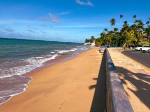 a beach with a fence and the ocean at OMERO Ocean Park in San Juan