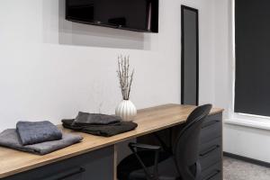 a desk with a vase on top of it at Cowgate Luxury Apartments in Peterborough