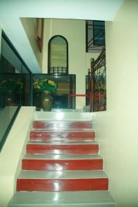 a staircase in a building with red and white steps at Hotel El Ejido in Quito