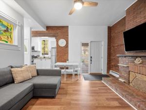 a living room with a couch and a flat screen tv at Shadyside, Pittsburgh, Modern and Accessible 2 Bedroom Unit2 with Free Parking in Pittsburgh
