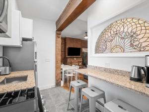 a kitchen with a counter with a stained glass window at Shadyside, Pittsburgh, Modern and Accessible 2 Bedroom Unit2 with Free Parking in Pittsburgh