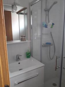 a bathroom with a sink and a shower at Atico vistas mar in Ribeira +41 photos