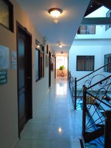 a hallway with a staircase in a building at Hotel El Ejido in Quito