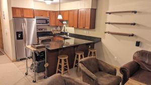 a kitchen with a counter and some bar stools at Cozy Townhouse on the main bus line in Breckenridge