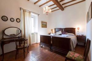 a bedroom with a bed and a table and a mirror at Casa Dinda in Città di Castello +15 photos