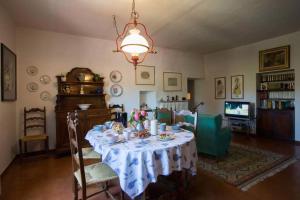 a dining room table with a blue and white table cloth at Casa Dinda in Città di Castello