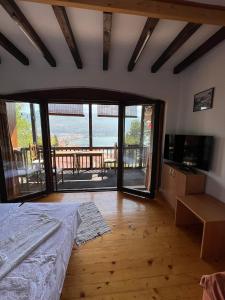 a bedroom with a bed and a view of a balcony at Chardak Apartments in Ohrid