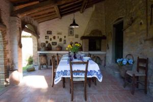 a dining room with a table with flowers on it at Casa Dinda in Città di Castello