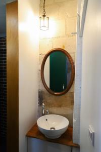a bathroom with a sink and a mirror at La tanière du sorcier in Saumur