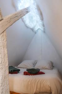 a bed in a room with a roof at La tanière du sorcier in Saumur