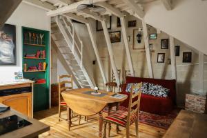 a living room with a table and a couch at La tanière du sorcier in Saumur