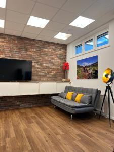 a living room with a couch and a flat screen tv at *Wohnung NELE* einzigartig in VS mit Parkplatz in Villingen-Schwenningen