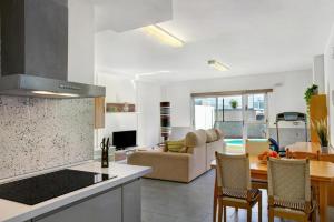 a kitchen and living room with a couch and a table at Villa Luxury Las Mesas in Las Palmas de Gran Canaria