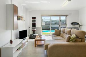 a living room with a couch and a tv at Villa Luxury Las Mesas in Las Palmas de Gran Canaria