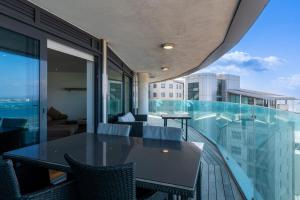 a balcony with a table and chairs on a building at OCEAN Plaza Suite 07-Hosted by Sweetstay in Gibraltar