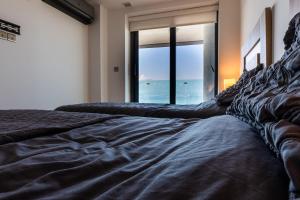 a bedroom with a bed with a view of the ocean at OCEAN Plaza Suite 07-Hosted by Sweetstay in Gibraltar
