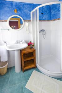 a bathroom with a white sink and a shower at Fonte San Pedrín in Cajide +21 photos
