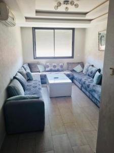 a living room with a couch and a table at Chez Dani in Agadir