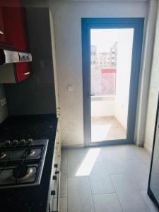 une cuisine avec une porte menant à un balcon dans l'établissement Chez Dani, à Agadir