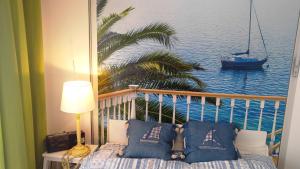 a balcony with a view of the ocean and a boat at Musa Mar studio with balcony panoramic view in the residential area in Quarteira