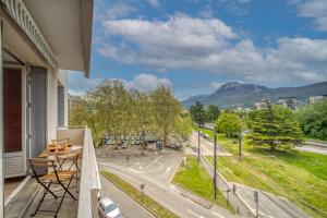 a balcony with a table and a view of a street at Le Lyon - Bastille / Esplanade in Grenoble