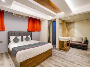 a bedroom with a bed and a sink and a desk at Sairup Stays in Navi Mumbai