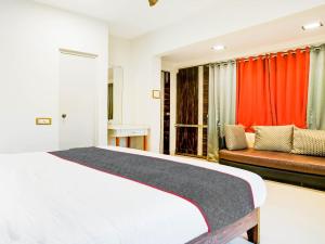 a bedroom with a bed and a couch at Sairup Stays in Navi Mumbai