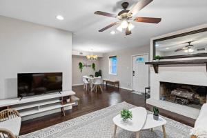 a living room with a fireplace and a ceiling fan at Cozy suite in Buckhead/Midtown + free parking in Atlanta