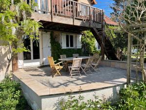 un patio con tavolo e sedie in una casa di Domaine entier Le Clos des Trois Provinces 20 personnes Zoo Beauval a Noyers-sur-Cher