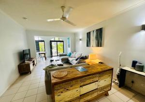 a living room with a couch and a table at Appartment in Palm Cove in Palm Cove