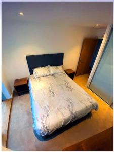 a bedroom with a large bed in a room at lovely one bedroom apartment in Ilford town in Ilford