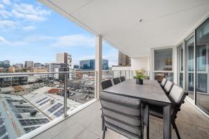 a dining room with a view of the city at Ignite @ Park Tce Apartments in Adelaide