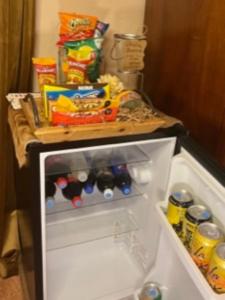 an open refrigerator filled with food and drinks at Yellowstone Cattle Baron EnSuite, Private Entrance & Parking - Prairie Rose B&B in Cheyenne +41 photos