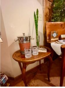 un tavolo con due bicchieri e una pianta in vaso di Yellowstone Cattle Baron EnSuite, Private Entrance & Parking - Prairie Rose B&B a Cheyenne