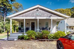 una casa blanca con porche y un coche aparcado delante en Island Breeze, en Oak Bluffs