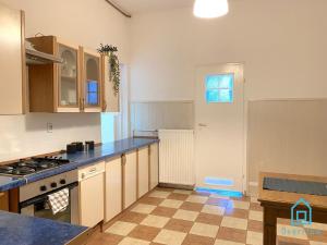 a kitchen with a stove and a counter top at Nest Room in Gdańsk