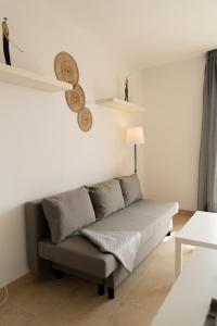 a living room with a couch and a table at Suite La Envía Golf in Almería +15 photos